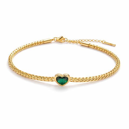 Gold bracelet with a heart-shaped green gemstone on a white background