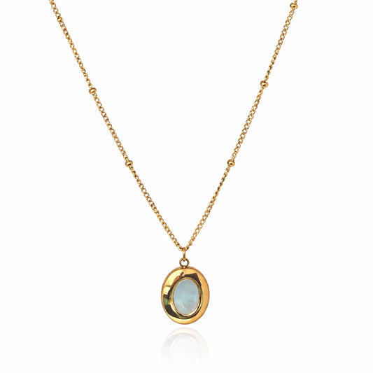 Oval opal pendant necklace in Yubiraa gold tone with delicate chain, minimal design on white background