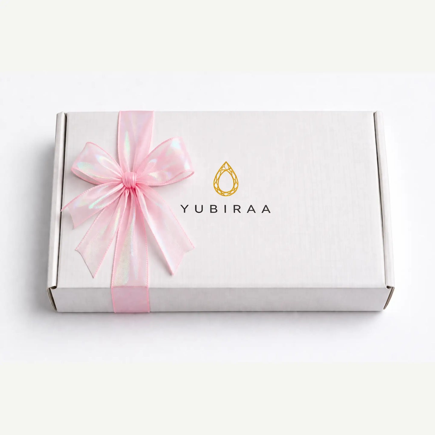 White gift box with a pink ribbon and Yubiraa logo on a white background
