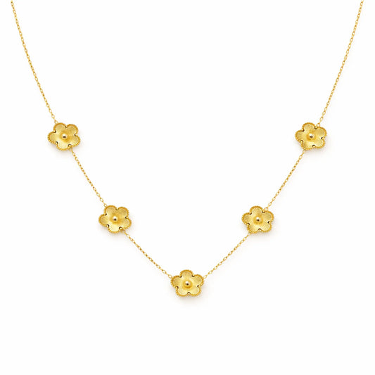 Gold necklace with floral pendants on a white background