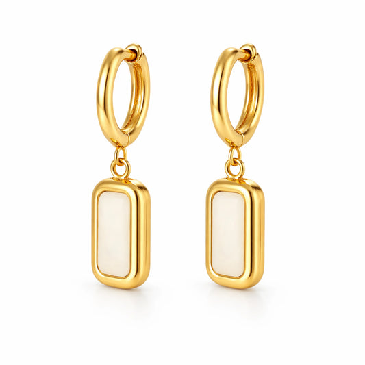 Gold hoop earrings with white stone drops on a white background