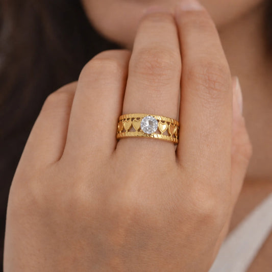 Model wearing gold love loop solitaire ring with heart loop band and round cubic zirconia – yubiraa