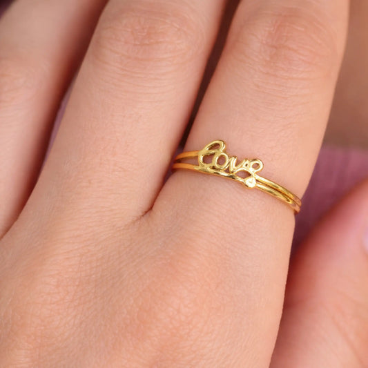 Model wearing YUBIRAA love script adjustable gold ring, minimal everyday jewellery styling