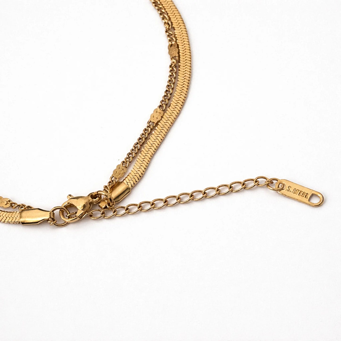Gold chain bracelet with a clasp on a white background