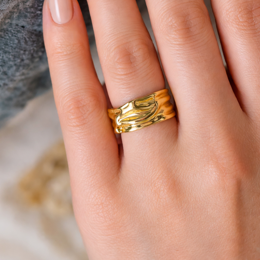 YUBIRAA molten gold ring worn on finger, showcasing bold sculptural design and adjustable fit