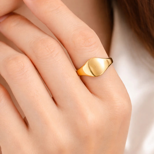 Model wearing gold polished signet ring showcasing minimal design