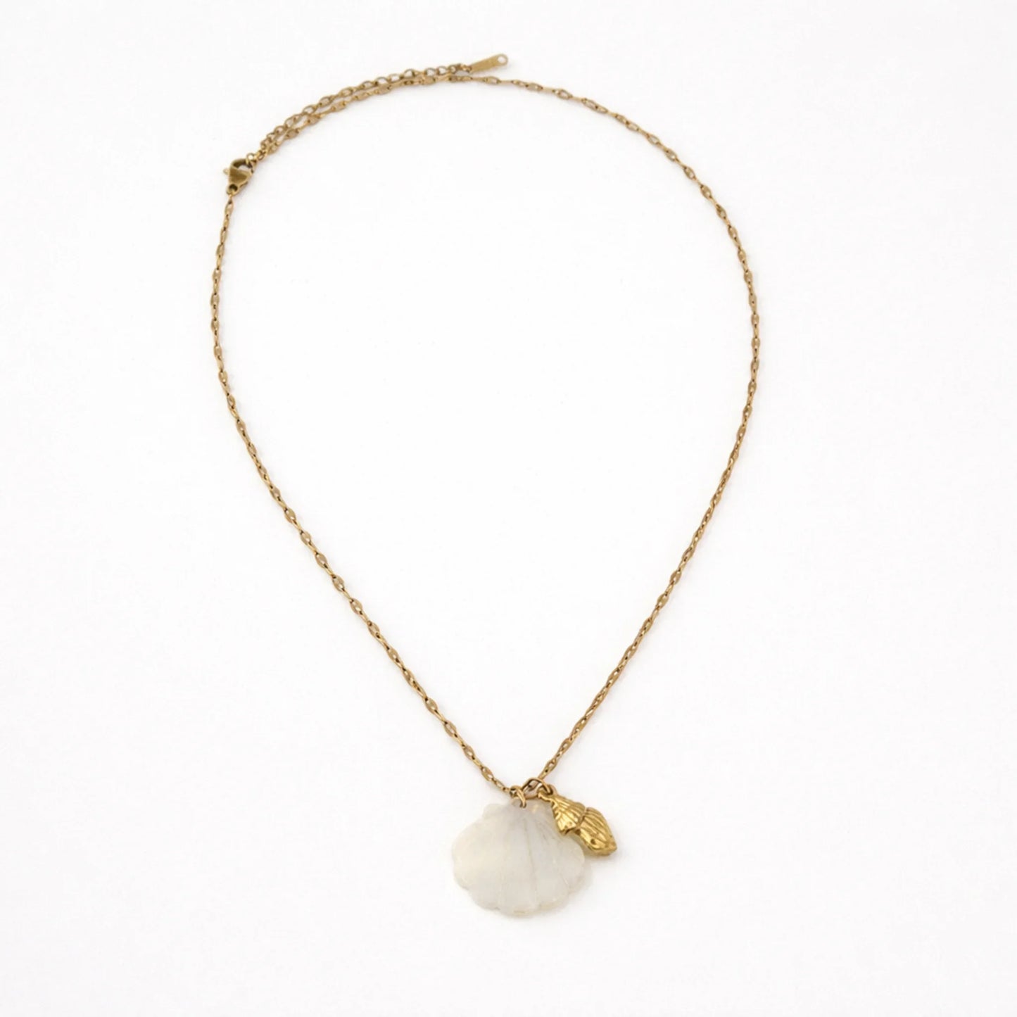 Gold chain necklace with mother of pearl shell pendant shown in full length flat lay on white background