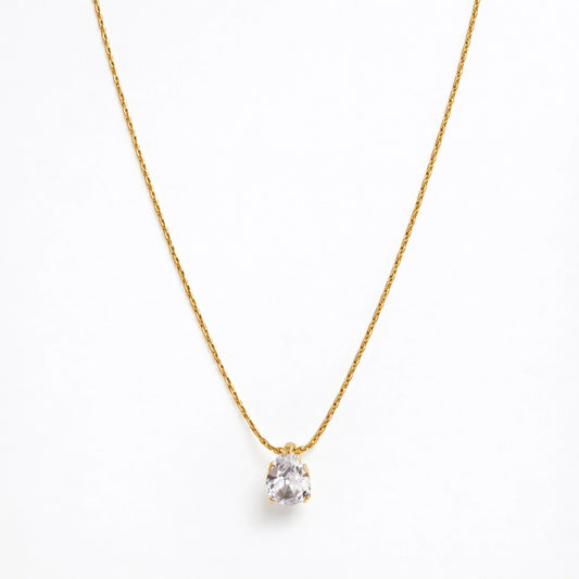 Gold necklace with a clear pendant tear drop on a white background