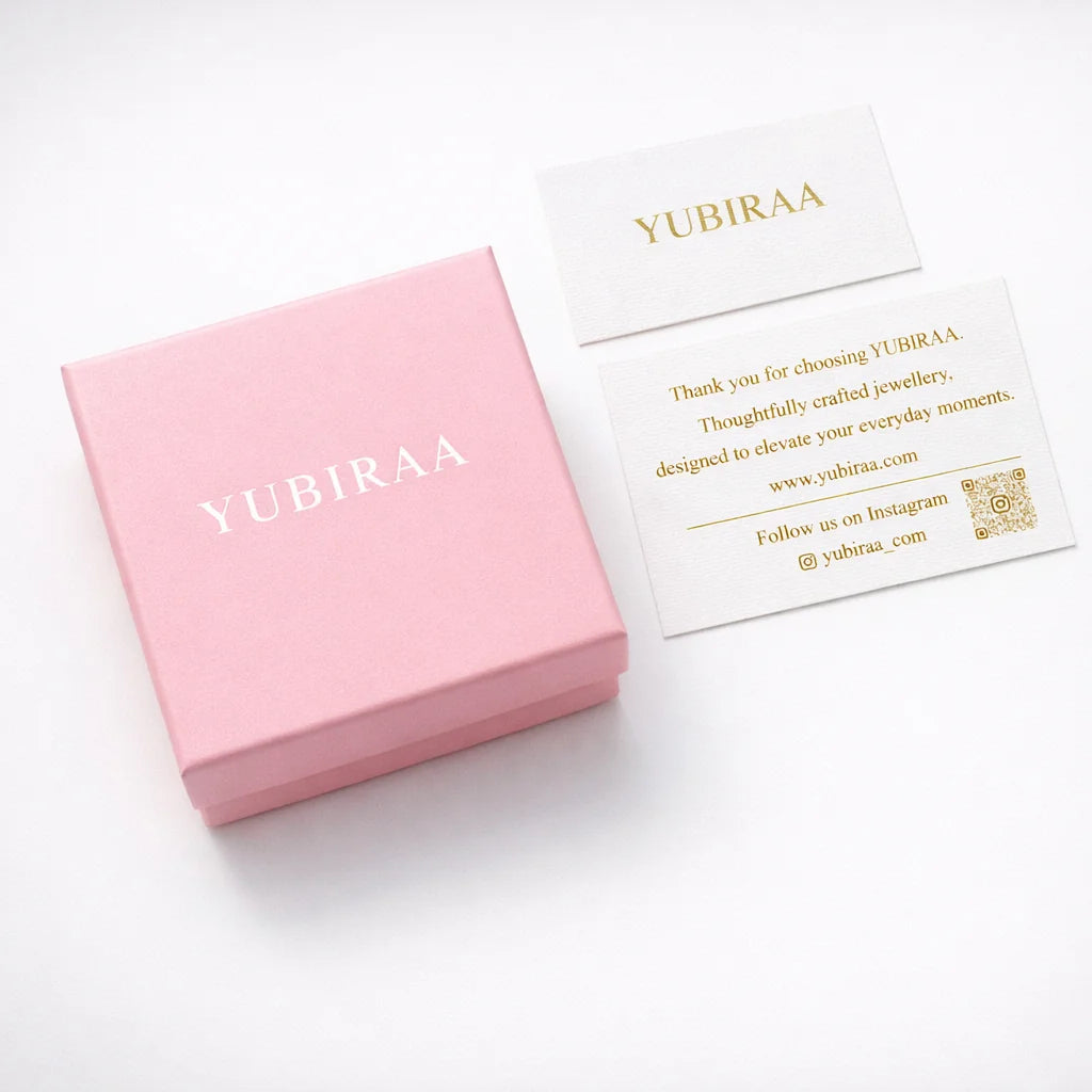 Pink jewelry box with 'YUBIRAA' branding on a white background
