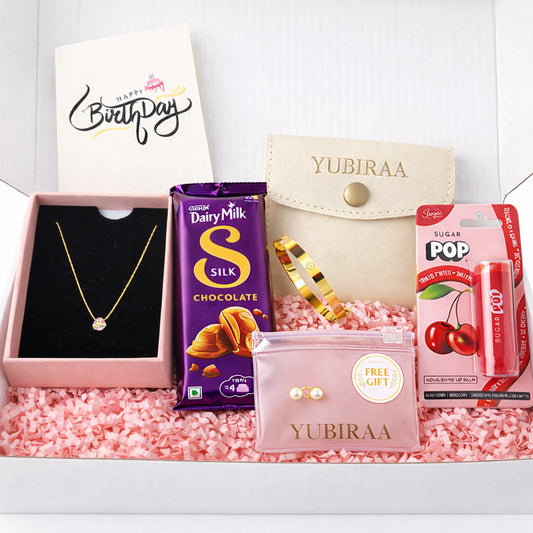 Gift box with jewelry, chocolate, and lip balm pack on a white background