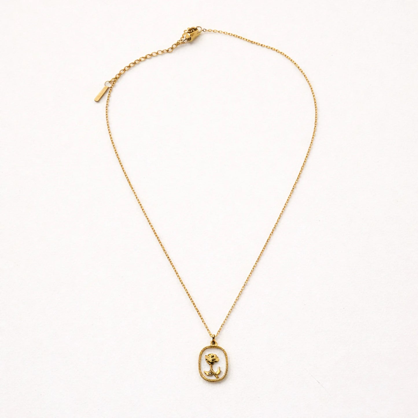 YUBIRAA rose pendant necklace flatlay on white background, minimal anti tarnish gold jewellery