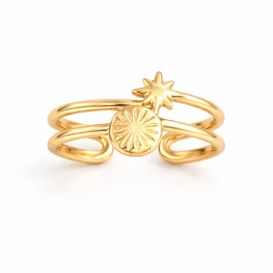 Gold ring with star and circle design on a white background