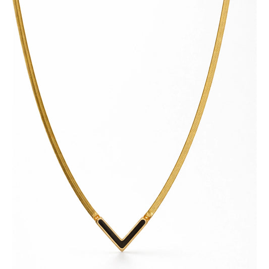 Gold necklace with a black pendant on a white background