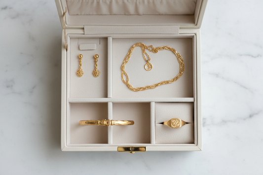 Neatly organised gold anti-tarnish jewellery storage box with separate compartments for earrings, necklace, bracelet and ring — YUBIRAA jewellery care guide