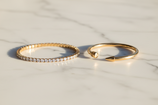 Tennis bracelet vs nail bracelet comparison — sparkling tennis bracelet and sleek sculptural nail bracelet by YUBIRAA, anti-tarnish 18K gold PVD plating