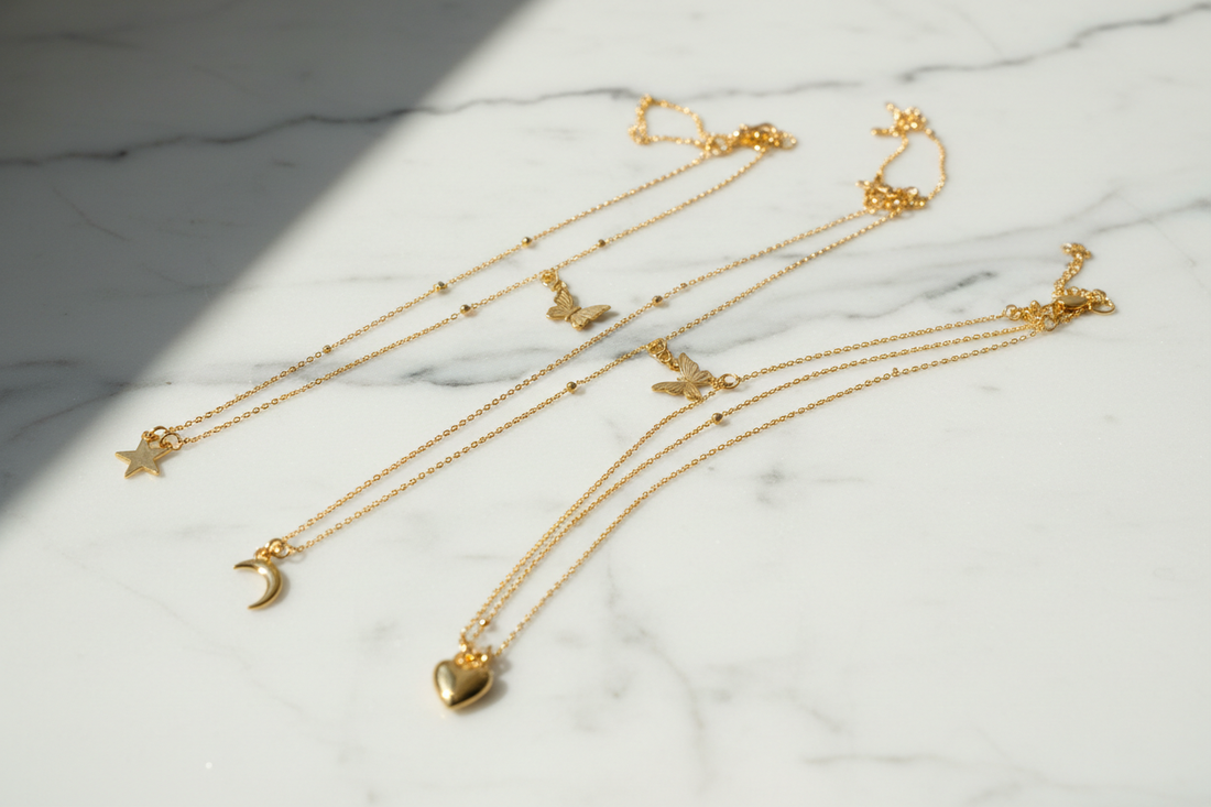 YUBIRAA gold anti-tarnish necklaces styled for different necklines — flat lay jewellery photography