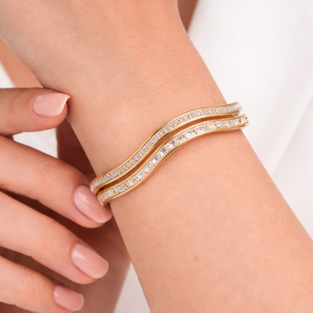 yubiraa anti tarnish Gold plated bracelet with clear stones on a wrist against a neutral background