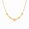 Gold necklace with floral designs on a white background