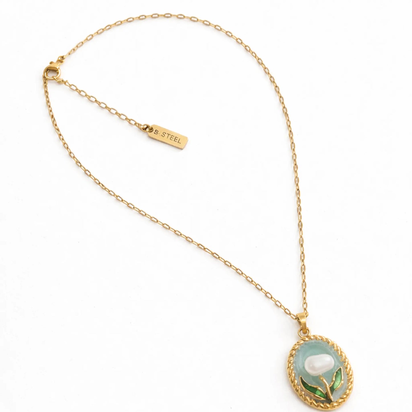 Anti tarnish gold plated floral pendant necklace with stainless steel chain and S.STEEL engraved tag displayed in a clean flat lay on white background.