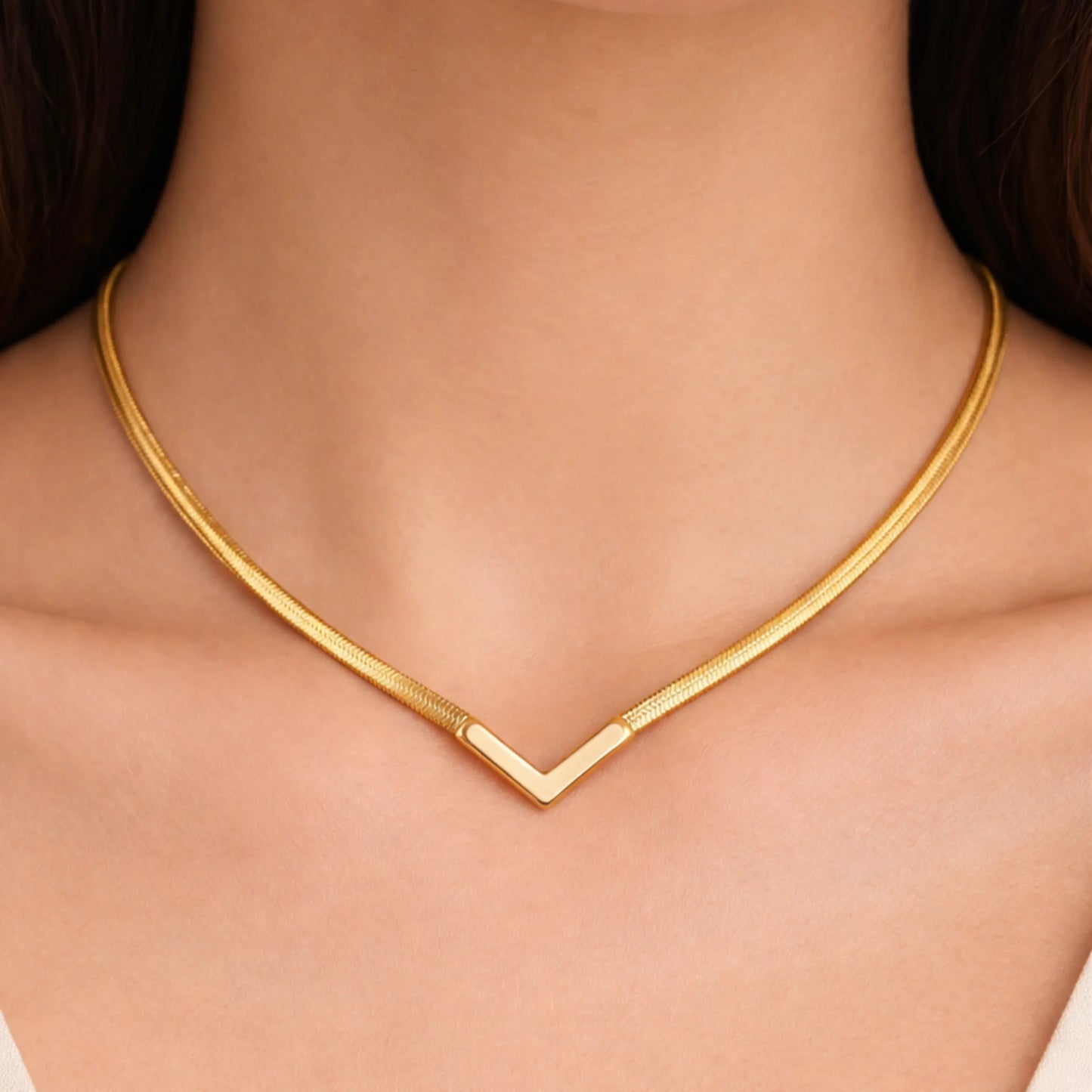 Gold necklace on a model's neck