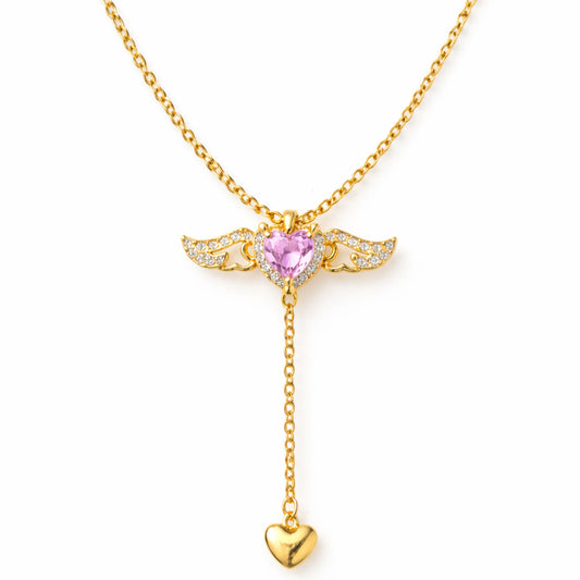 Gold necklace with a pink heart pendant on a white background