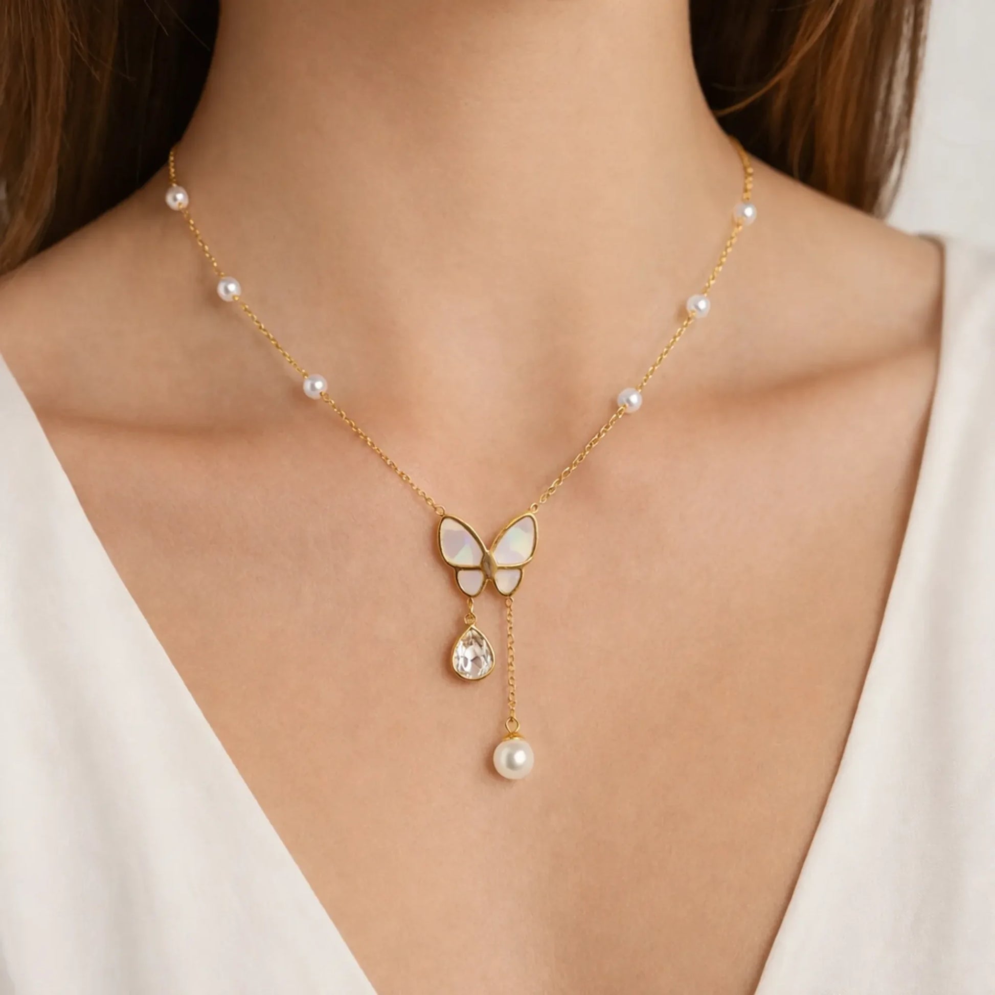 Model wearing butterfly pearl drop necklace in gold tone, showcasing elegant everyday jewellery styling