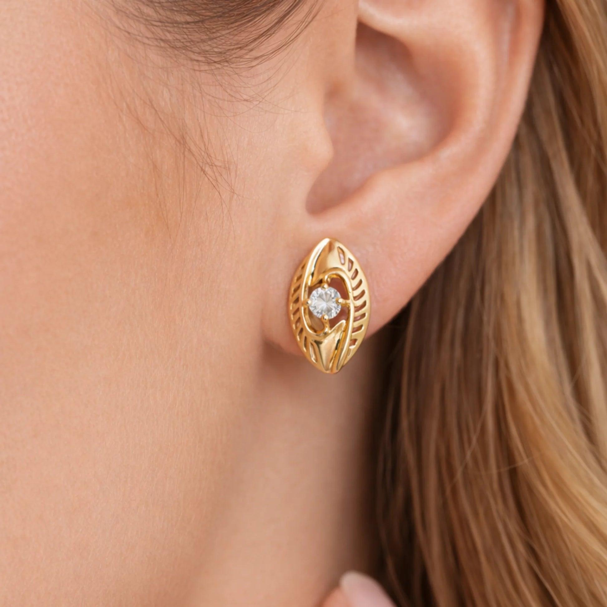 Celeste Marquise gold lever back earrings worn on ear close up view