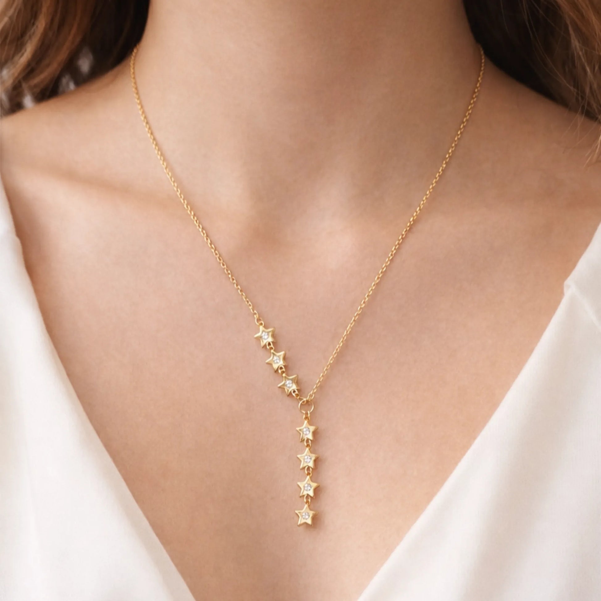 Yubiraa anti tarnish gold star drop necklace worn on model neck in minimal luxury style
