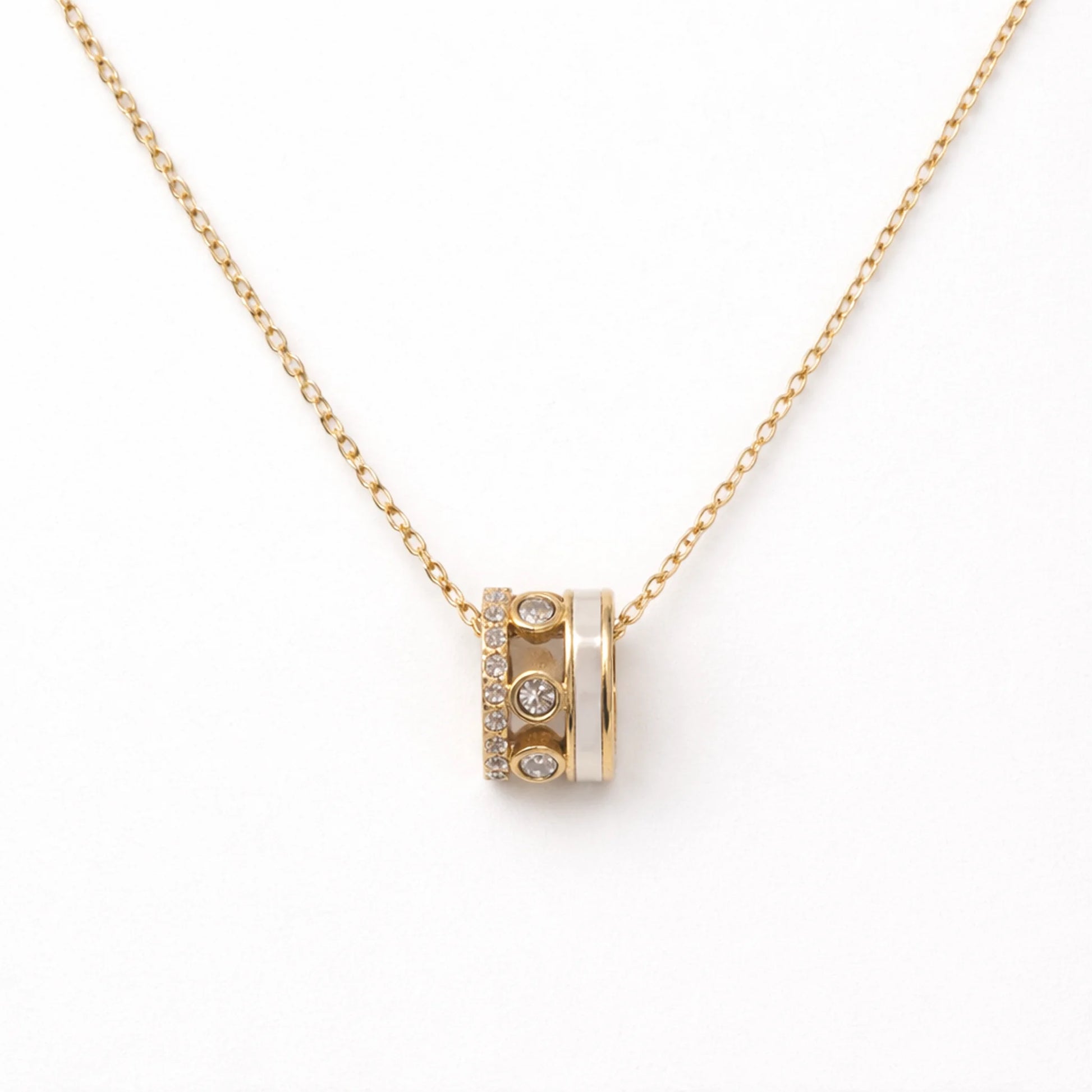 Gold necklace with a cylindrical pendant on a white background