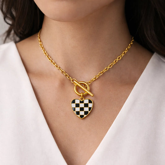 Model wearing Yubiraa Checker Heart Necklace styled as a modern statement piece
