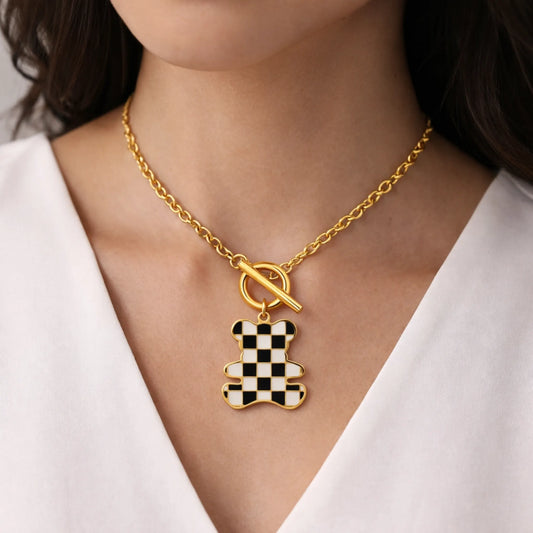 Model wearing Yubiraa checker teddy necklace as a playful everyday statement