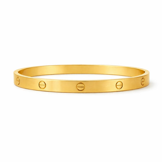 Gold bracelet with engraved symbols on a white background