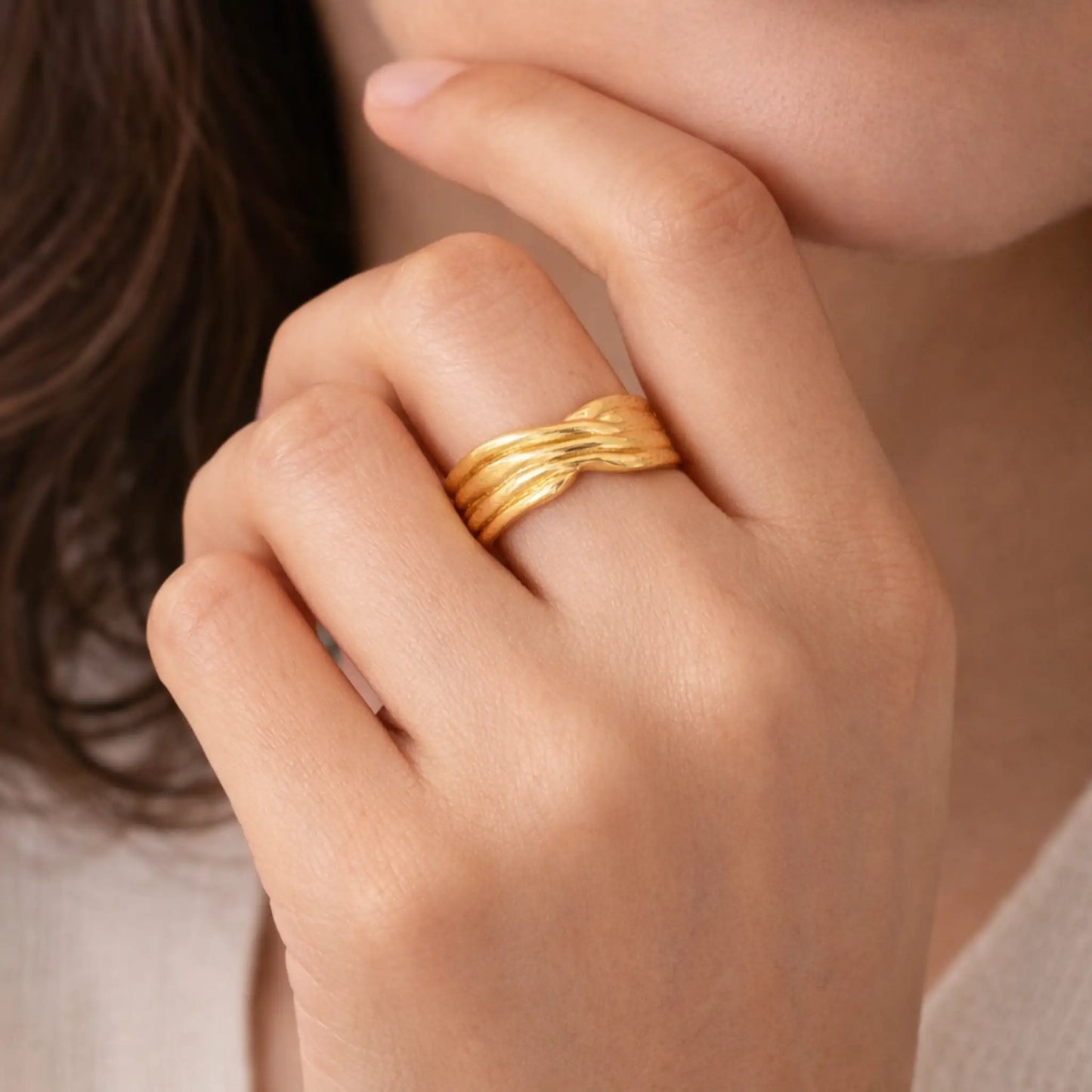 Model wearing YUBIRAA crossed weave adjustable gold ring, bold layered statement jewellery