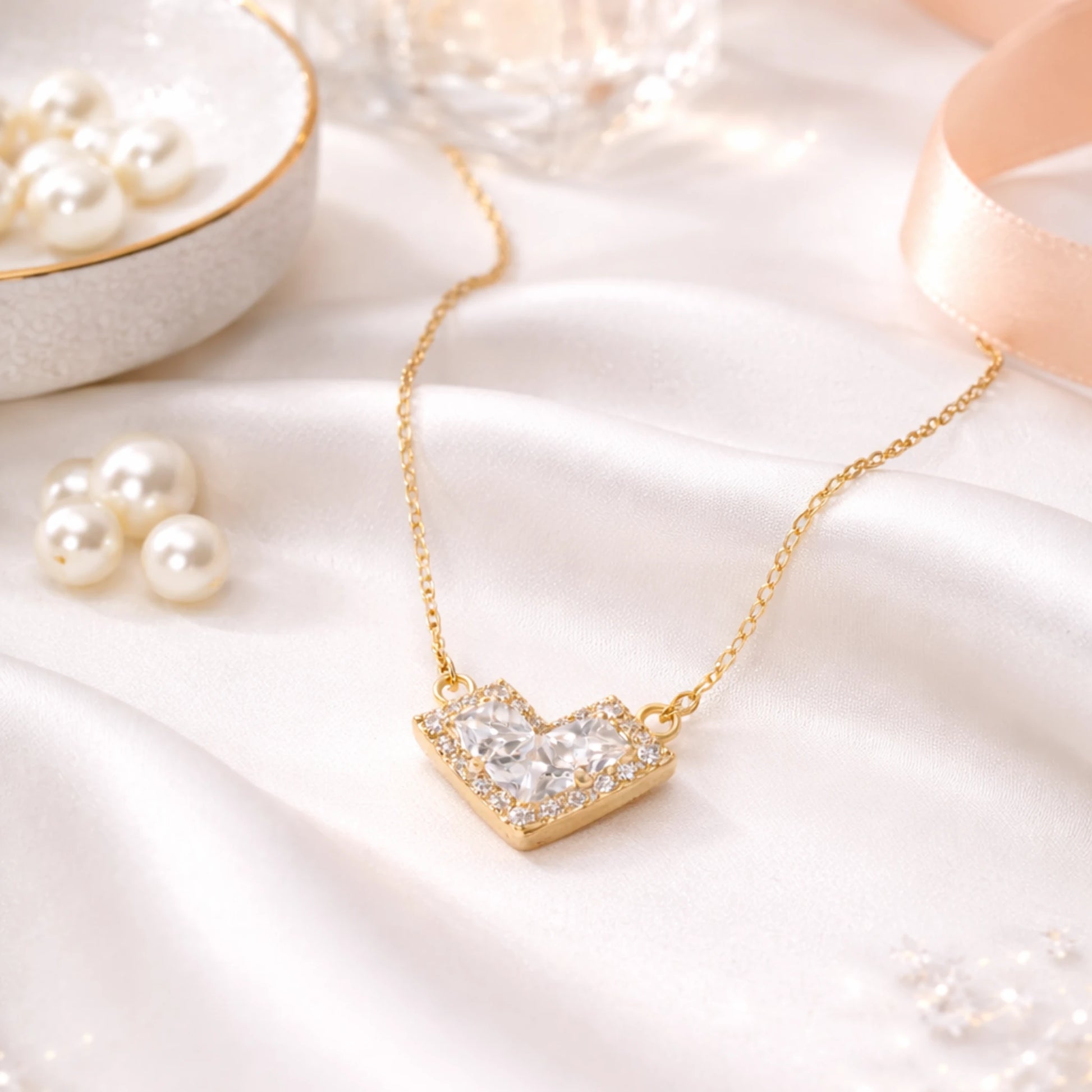 Gold necklace with a heart-shaped pendant on a soft white background