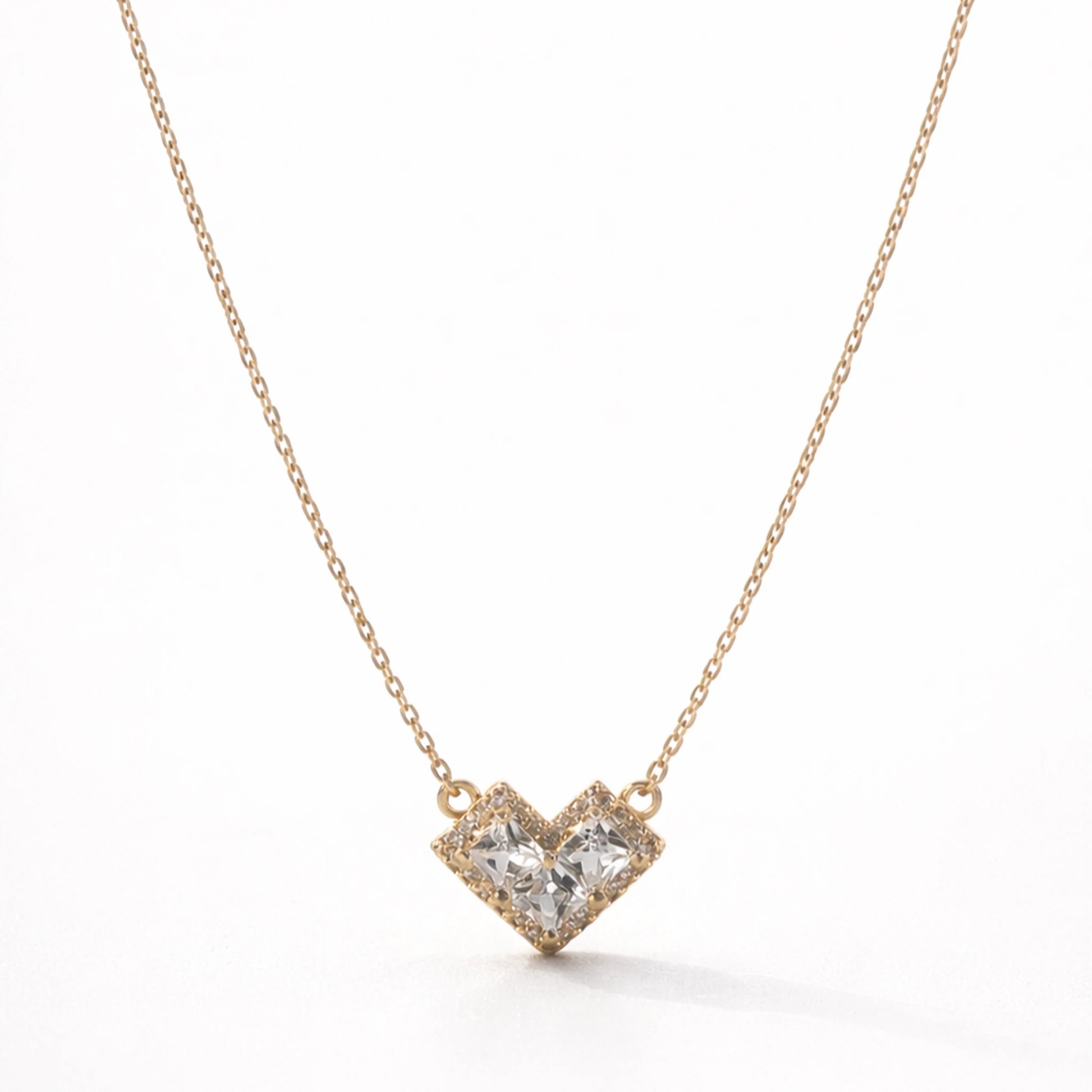 Heart-shaped diamond necklace on a white background