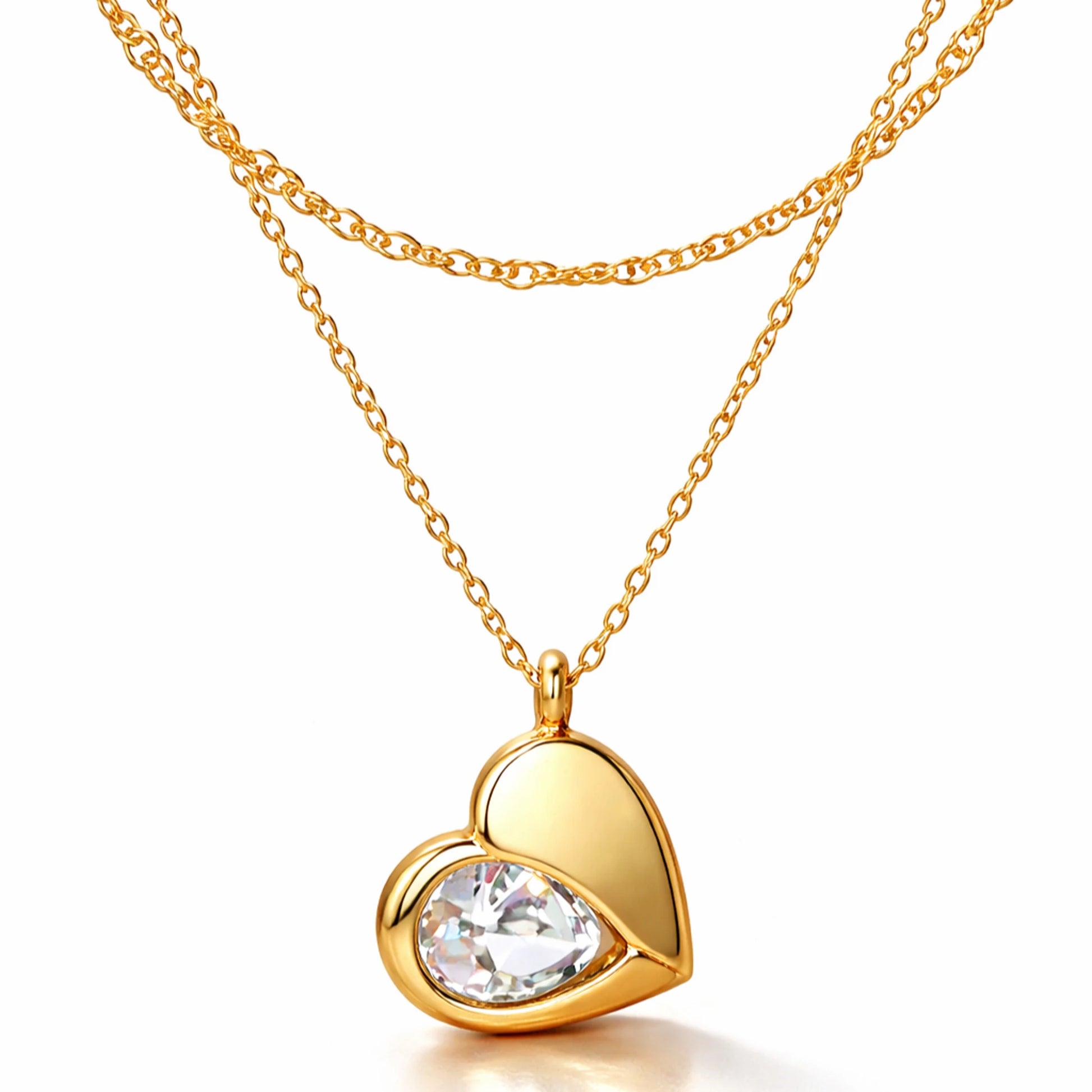 Gold heart-shaped necklace with a clear gemstone on a white background