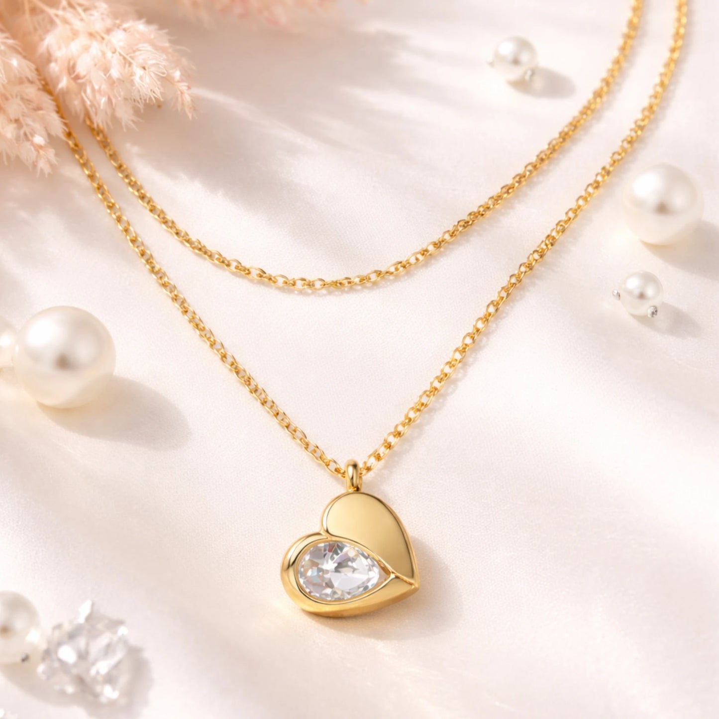Gold necklace with a heart-shaped pendant on a soft background