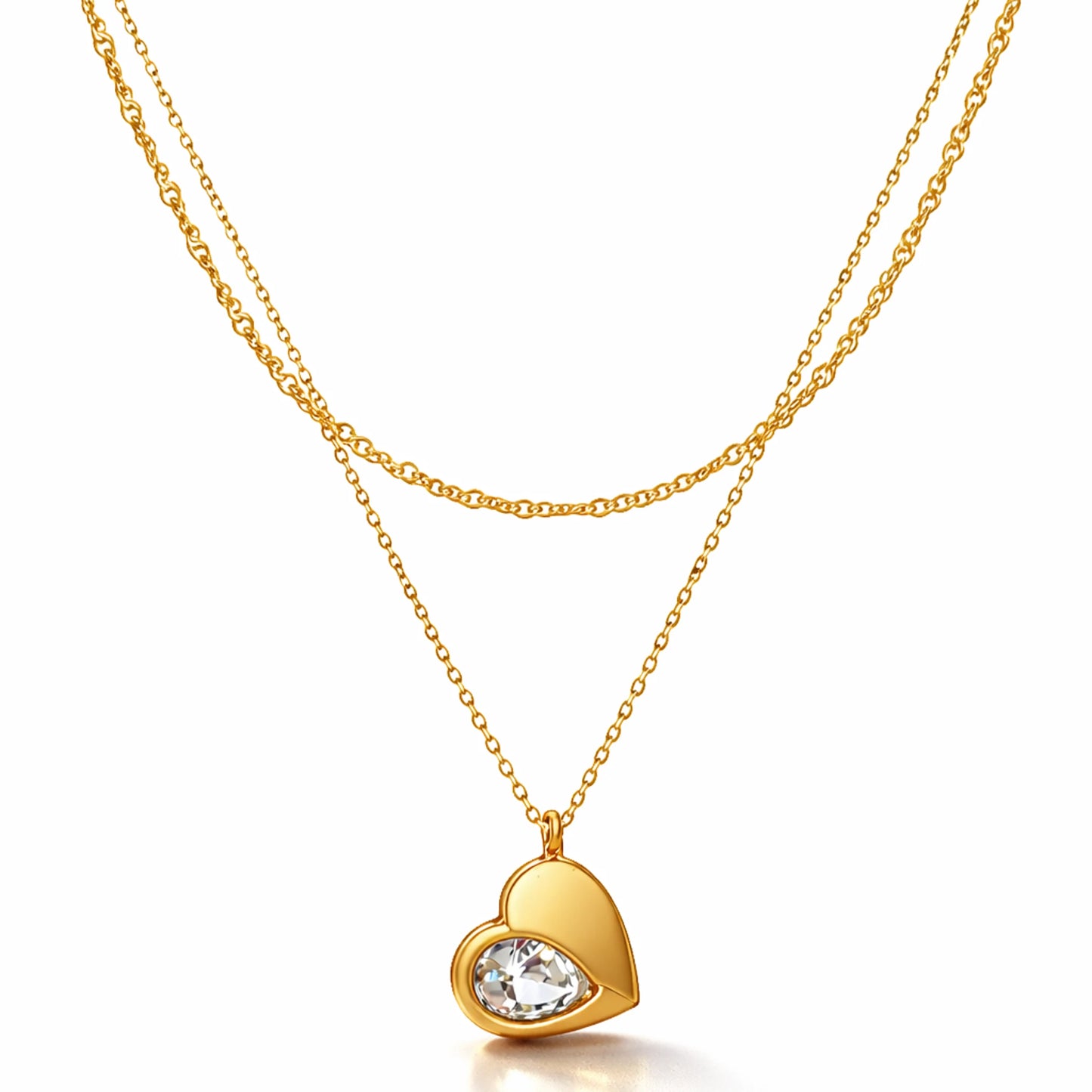Gold heart-shaped necklace with a clear gemstone on a white background