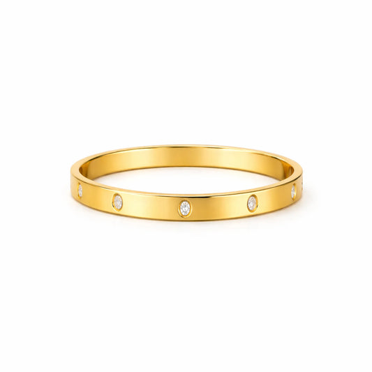 Gold bracelet with small diamonds on a white background