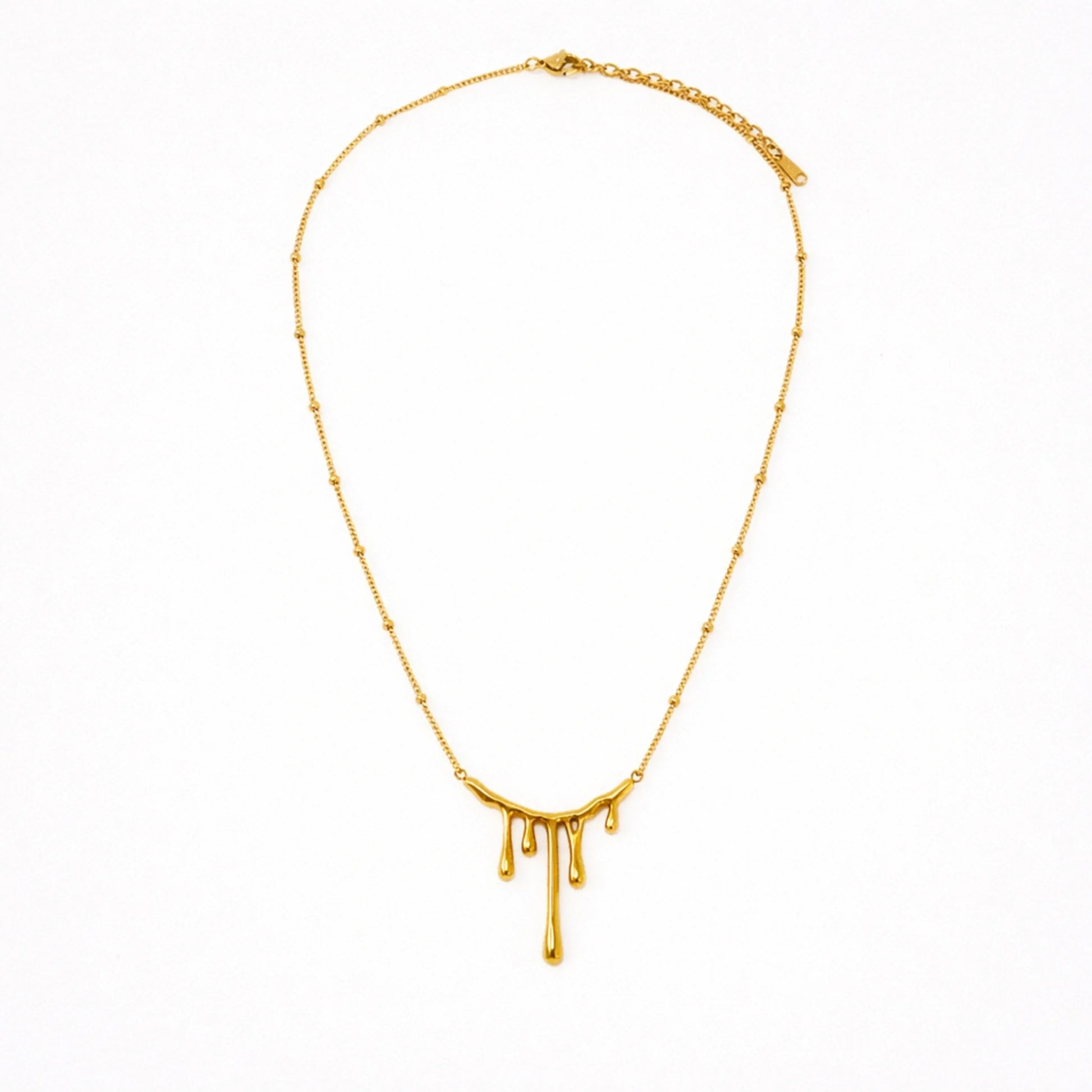 Gold necklace with a unique design on a white background