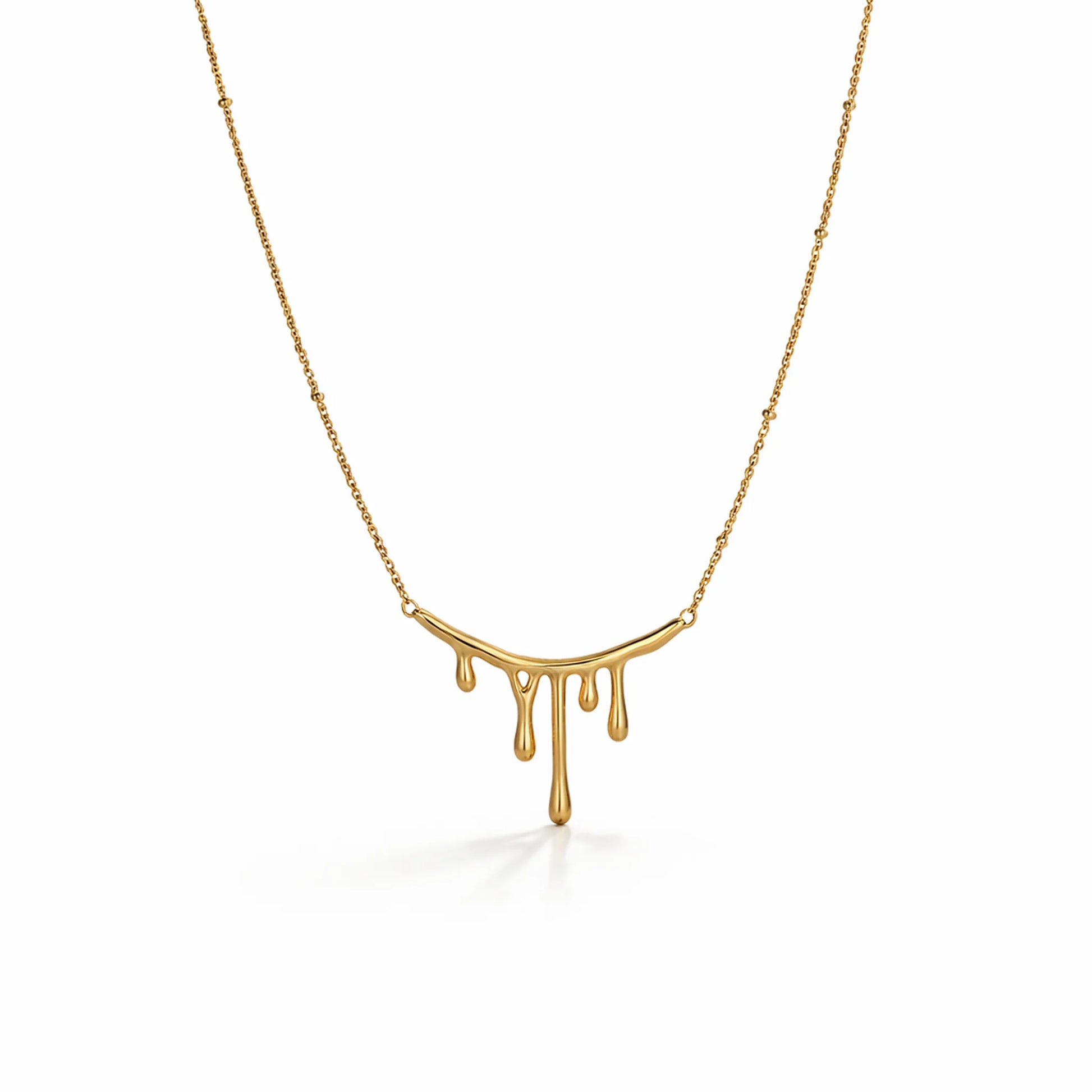 Gold necklace with a unique pendant design on a white background