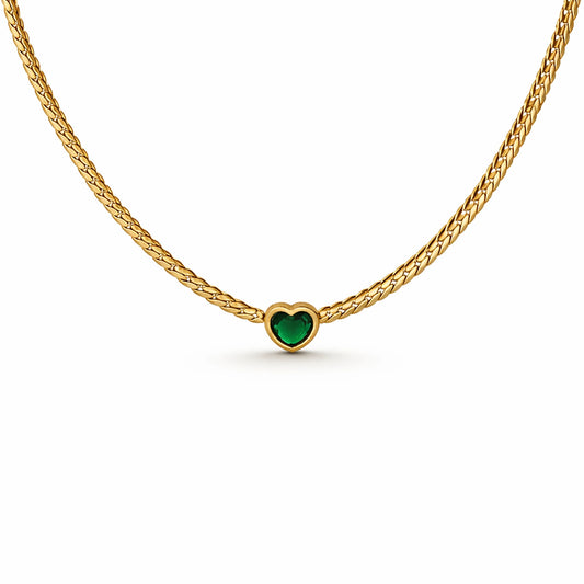 Gold necklace with a heart-shaped green gemstone on a white background