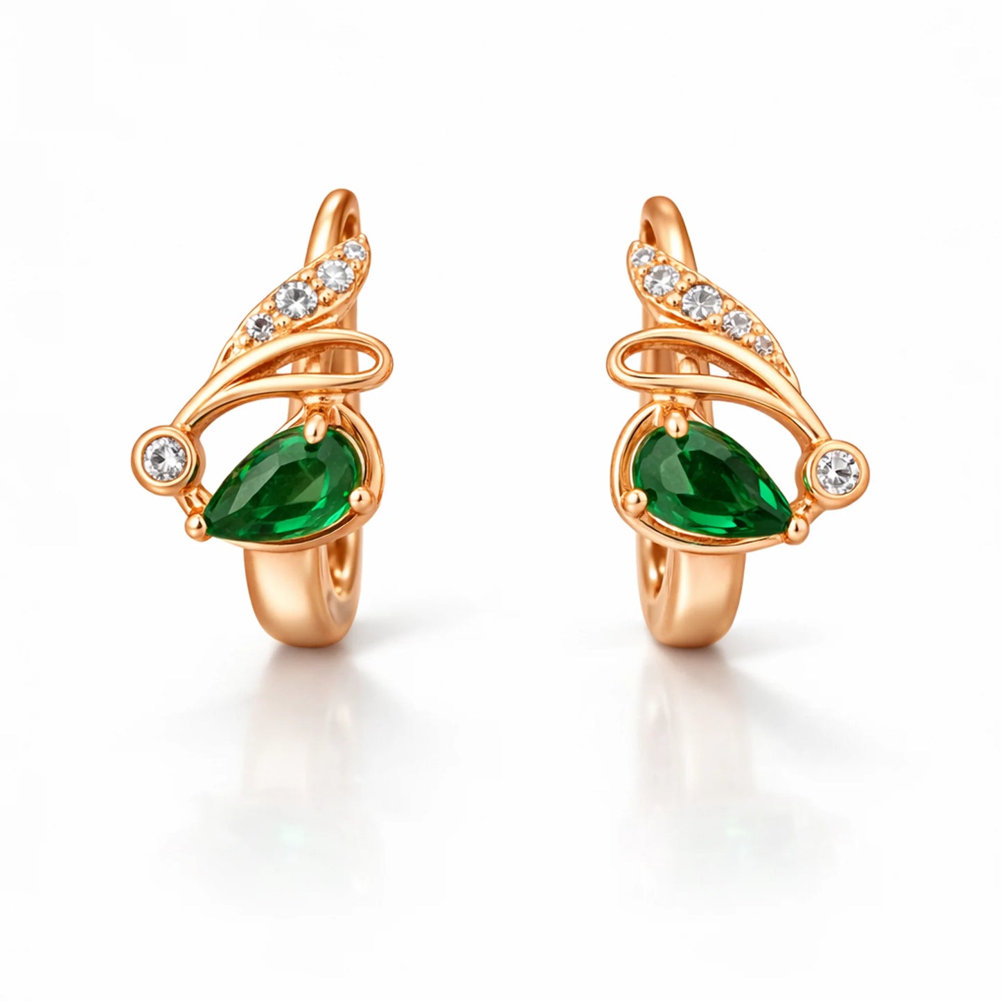 Rose gold huggie hoop earrings showing secure clasp closure and green stone setting