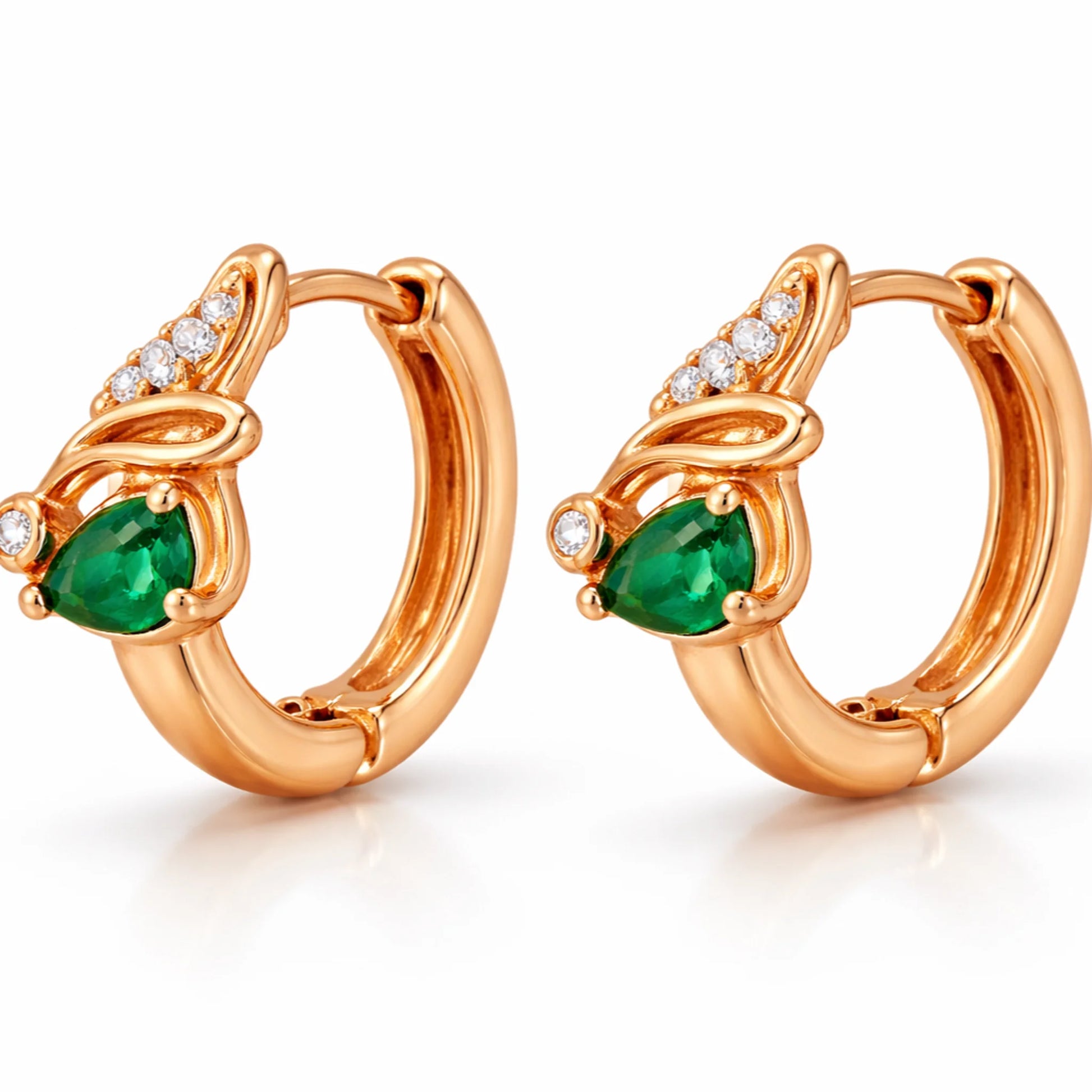 Side view of rose gold huggie hoop earrings featuring pear-cut green gemstone and diamond details