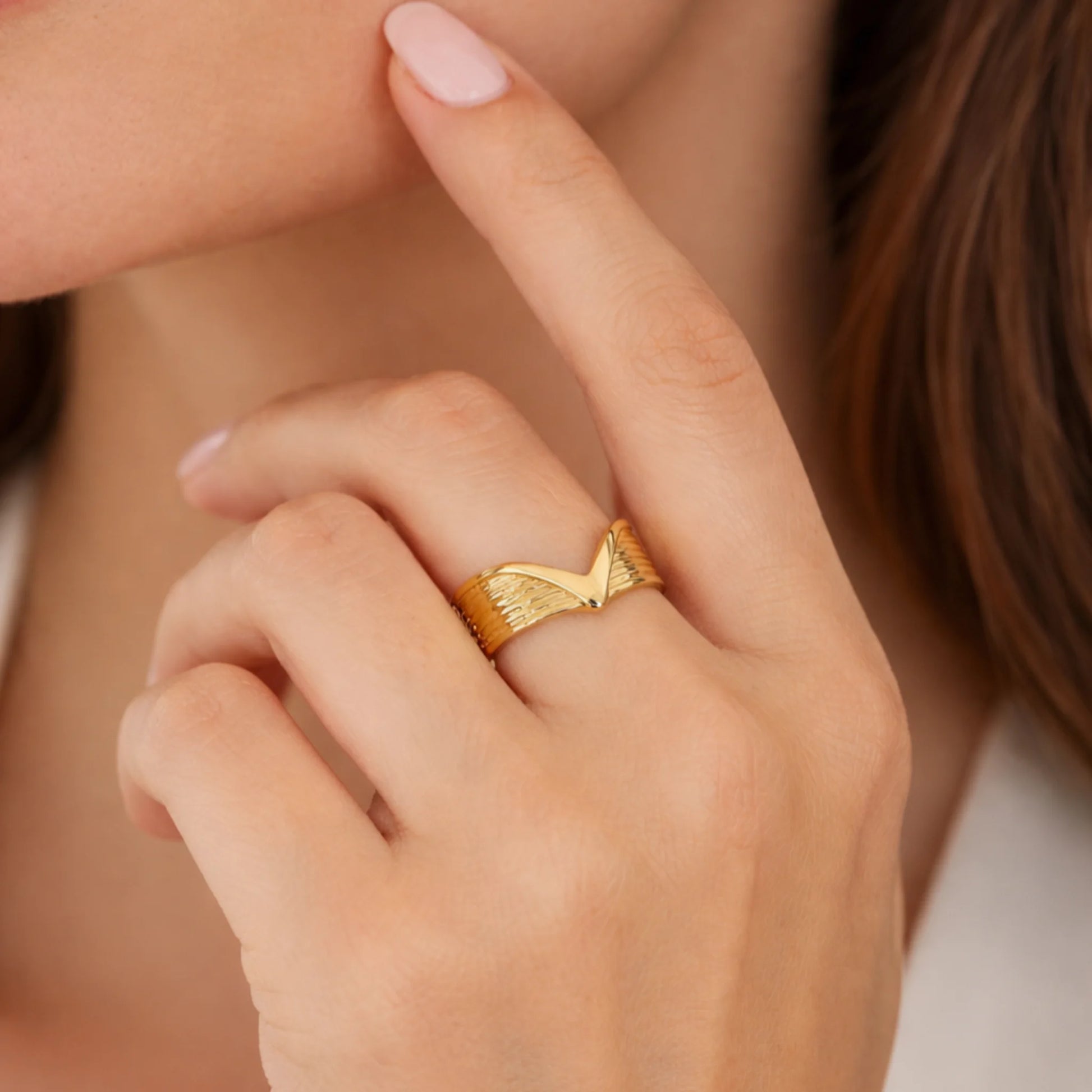 Gold ring on a finger worn by a person