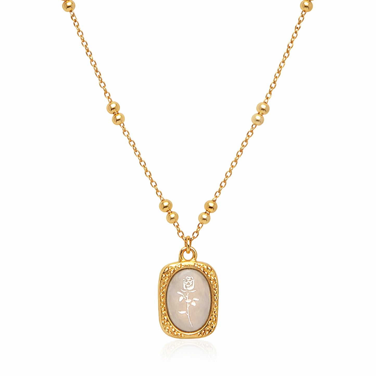 Ethereal Rose pendant necklace in gold plated stainless steel with ivory engraved rose charm on white background