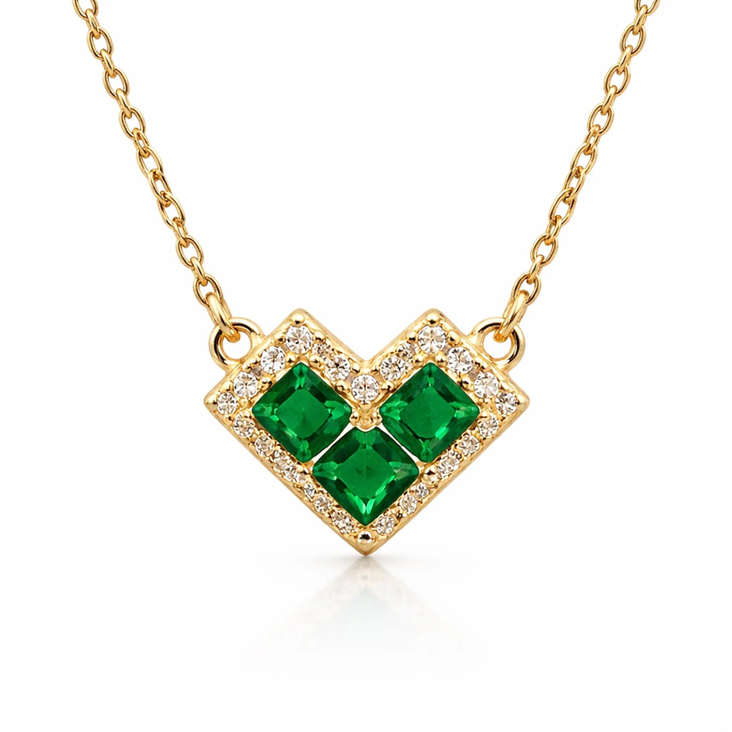 Yubiraa gold heart pendant necklace with emerald stones and anti tarnish finish on white background closeup