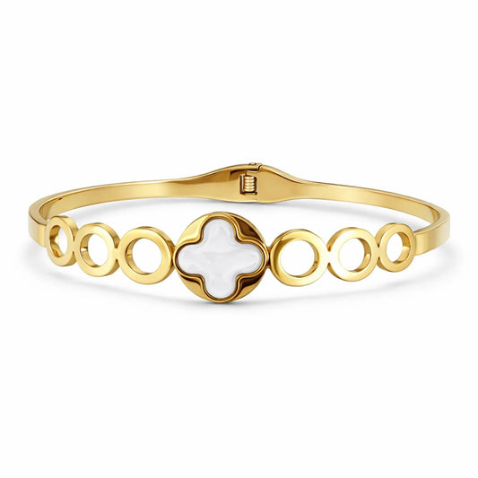 Gold bracelet with a central white stone on a white background. YUBIRAA Everyday Clover Gold Bracelet with white clover centerpiece and circular link design on white background