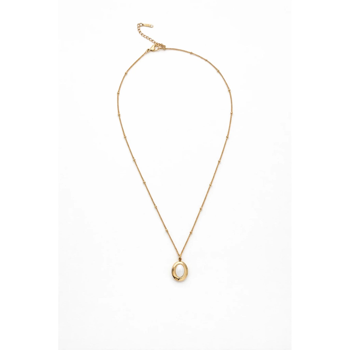 Minimal gold chain necklace with oval opal pendant shown full length in flat lay on white background