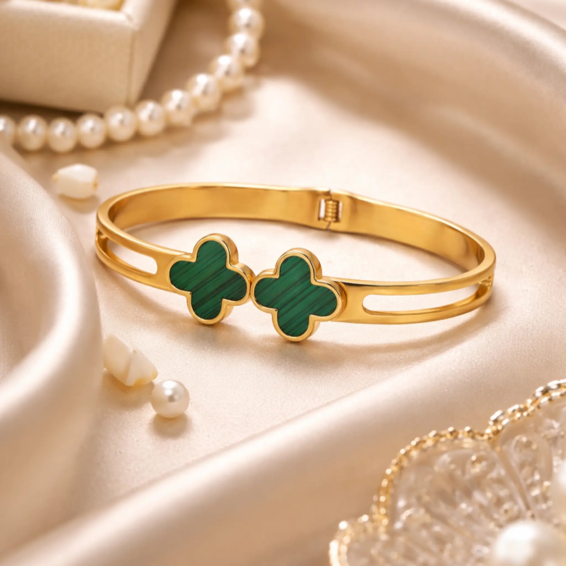 YUBIRAA green clover bracelet styled on satin fabric for luxury lifestyle look